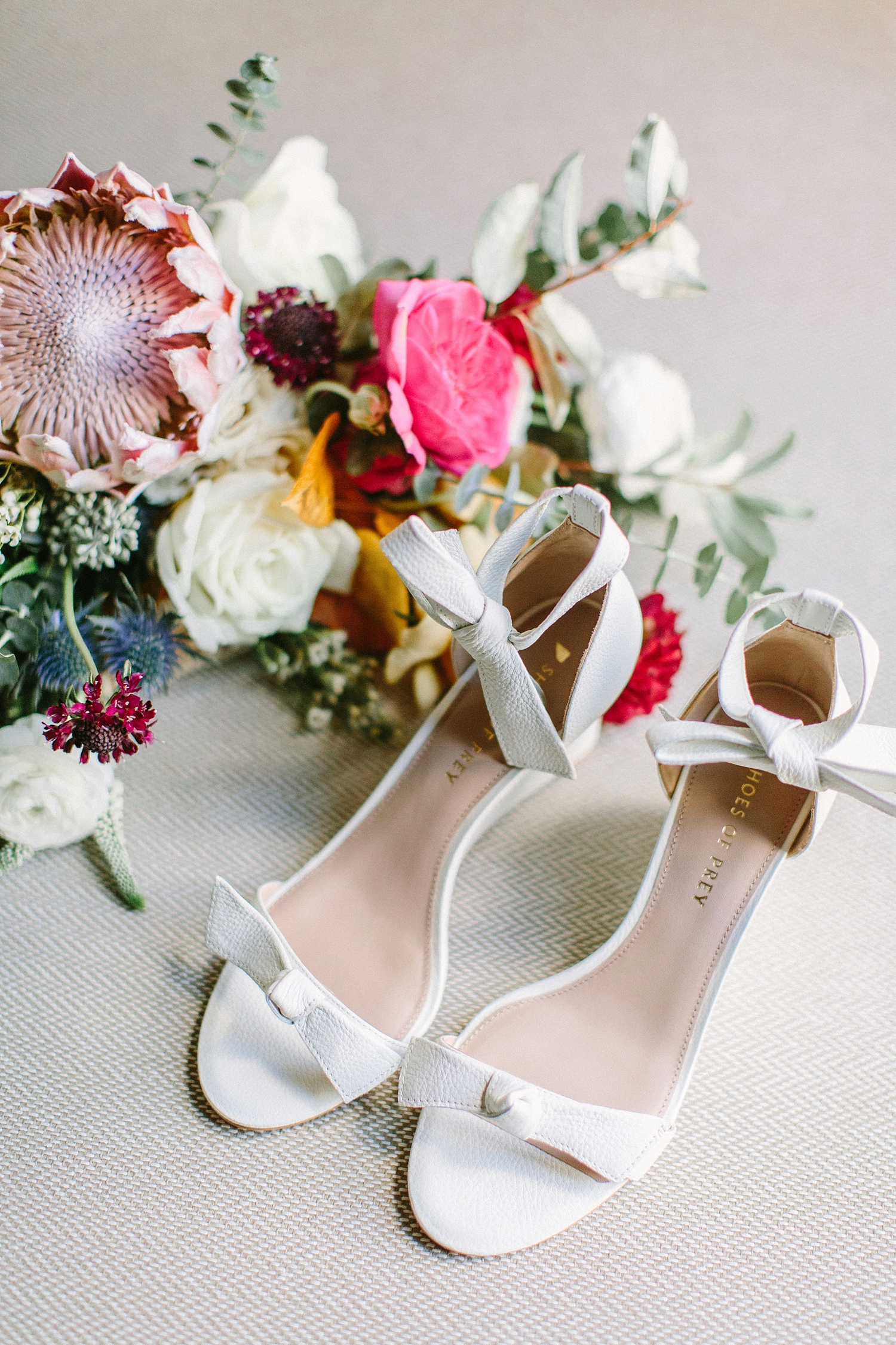 Colorful bridal bouquet and stylish wedding shoes
