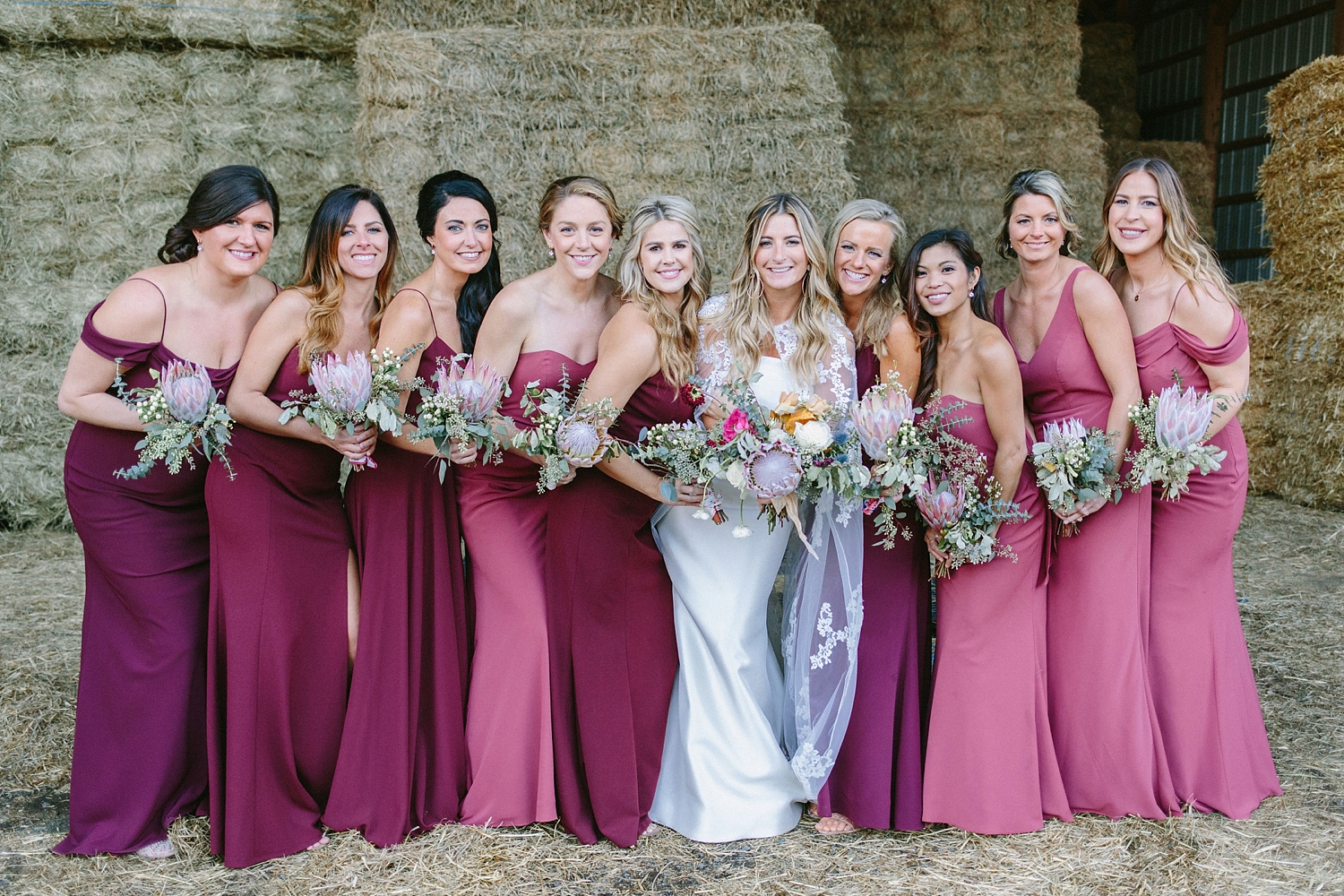 Bride and bridesmaids wearing reds and pinks