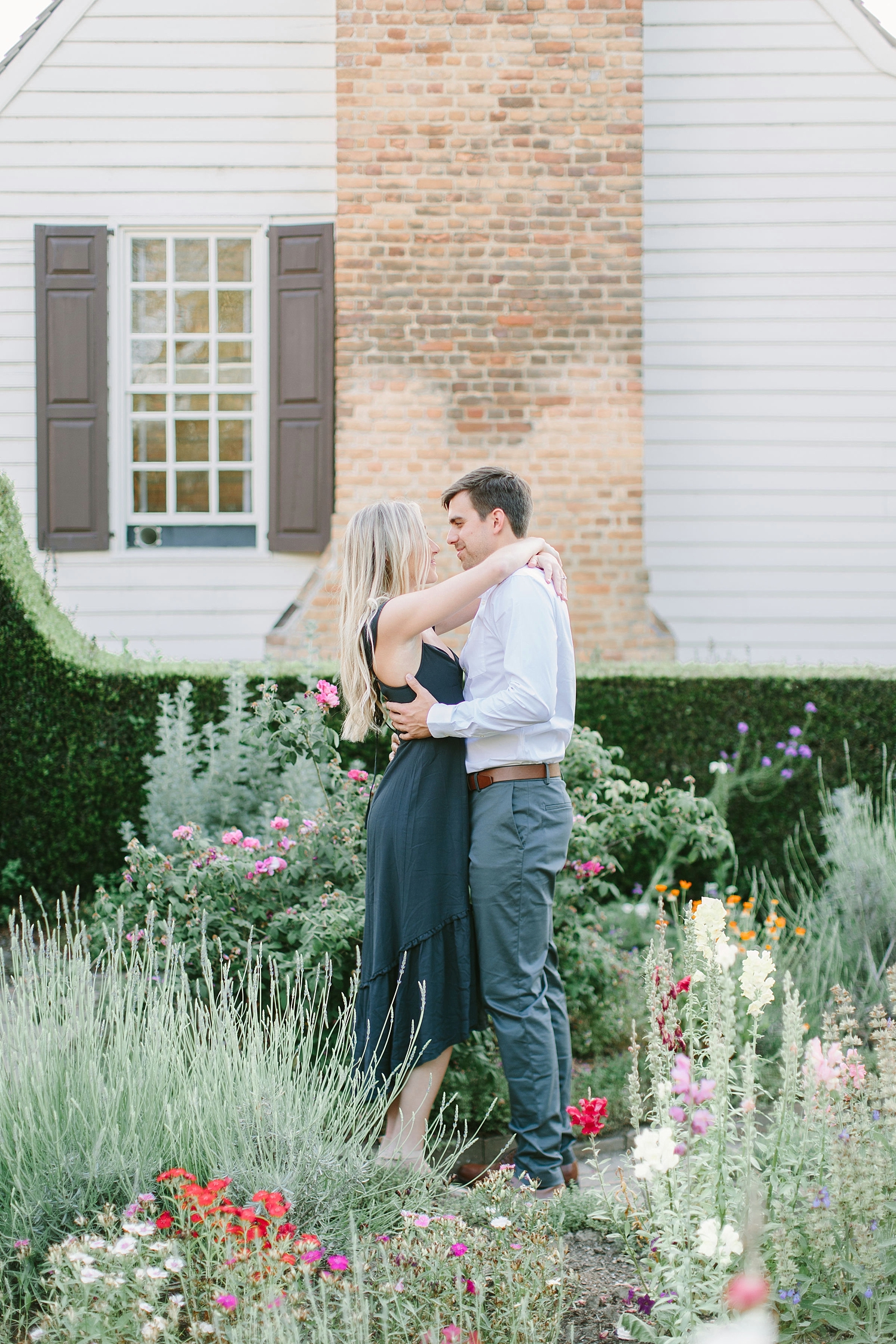 Couple embracing in a garden in colonial williamsburg